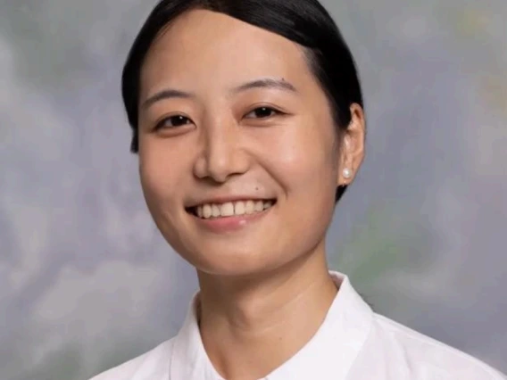 Professional photo of Xiao Ding wearing a button up white shirt 